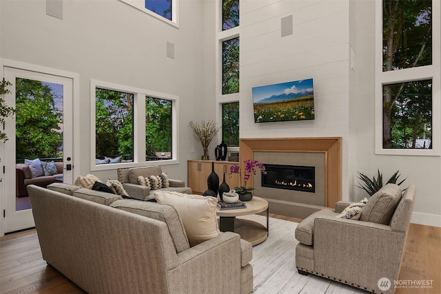 1704 172nd Ct NE, Bellevue, WA 98008 - living room with wood-type flooring, a towering ceiling, and a glass covered fireplace