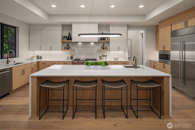 1704 172nd Ct NE, Bellevue, WA 98008 - kitchen featuring built in appliances, open shelves, light wood-style flooring, tasteful backsplash, and recessed lighting