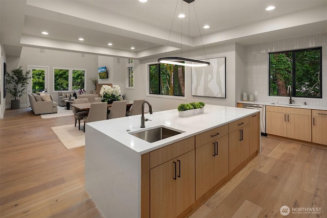 1704 172nd Ct NE, Bellevue, WA 98008 - kitchen with a tray ceiling, light brown cabinetry, recessed lighting, light wood-type flooring, and a center island with sink