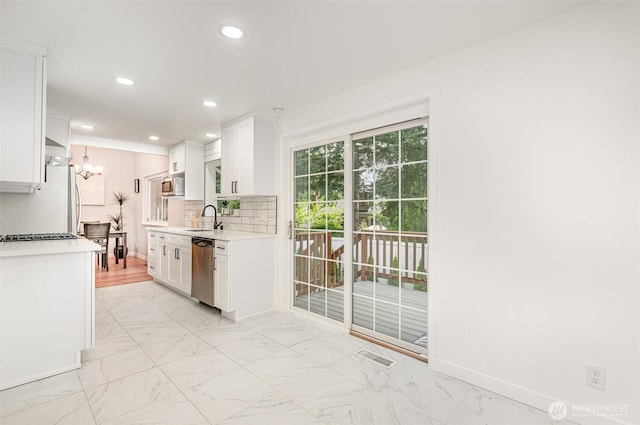 14249 NE 1st St, Bellevue, WA 98007 - kitchen featuring a chandelier, light countertops, appliances with stainless steel finishes, white cabinets, and recessed lighting