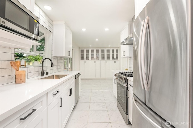 14249 NE 1st St, Bellevue, WA 98007 - kitchen with appliances with stainless steel finishes, light marble finish floors, white cabinets, light countertops, and recessed lighting