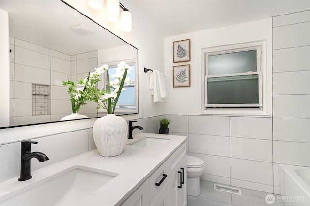 14249 NE 1st St, Bellevue, WA 98007 - bathroom featuring tile walls, double vanity, a tub to relax in, and tile patterned floors