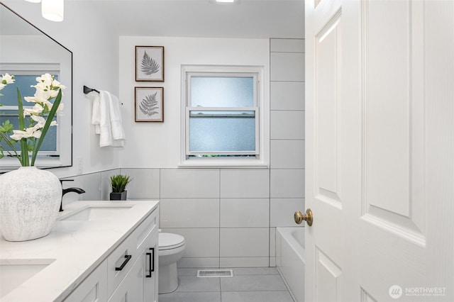 14249 NE 1st St, Bellevue, WA 98007 - bathroom with double vanity, tile patterned flooring, and tile walls