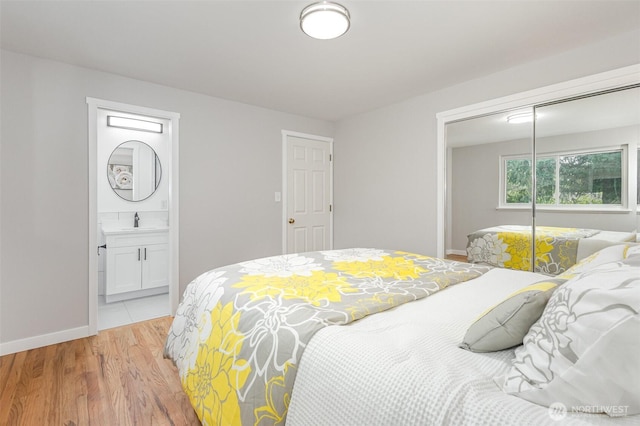 14249 NE 1st St, Bellevue, WA 98007 - bedroom featuring a closet, light wood-style flooring, and ensuite bath