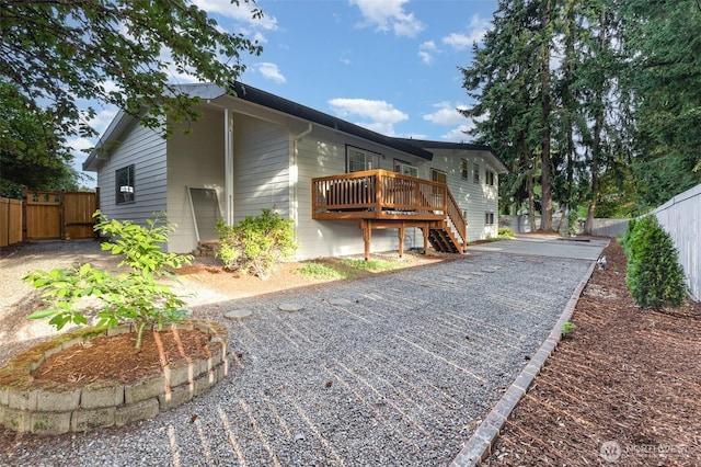 14249 NE 1st St, Bellevue, WA 98007 - view of side of home with a deck, a fenced backyard, and stairway