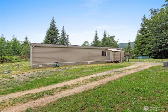 18025 Cedar Ponds Rd, Monroe, WA 98272 - rear view of property with crawl space, a shed, a lawn, and dirt driveway