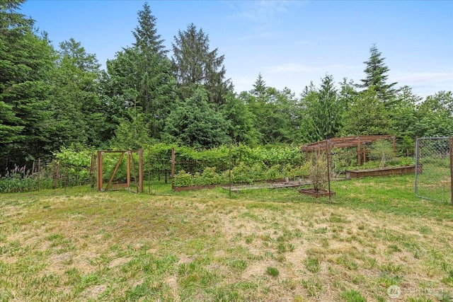 18025 Cedar Ponds Rd, Monroe, WA 98272 - view of green lawn with a vegetable garden and a view of trees