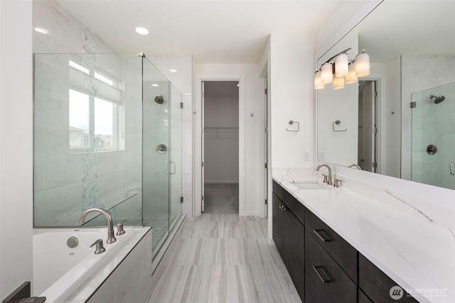 12619 176th St E, Puyallup, WA 98374 - bathroom featuring a shower stall, vanity, a bath, a walk in closet, and recessed lighting