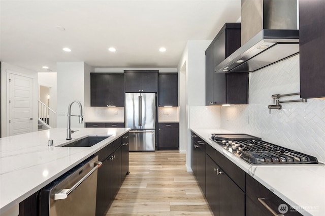12619 176th St E, Puyallup, WA 98374 - kitchen with stainless steel appliances, wall chimney exhaust hood, light wood-style floors, decorative backsplash, and recessed lighting