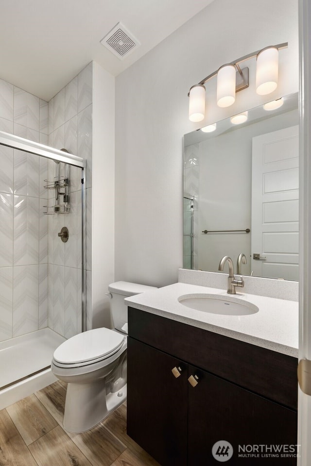 12619 176th St E, Puyallup, WA 98374 - bathroom with vanity, a stall shower, and wood finished floors