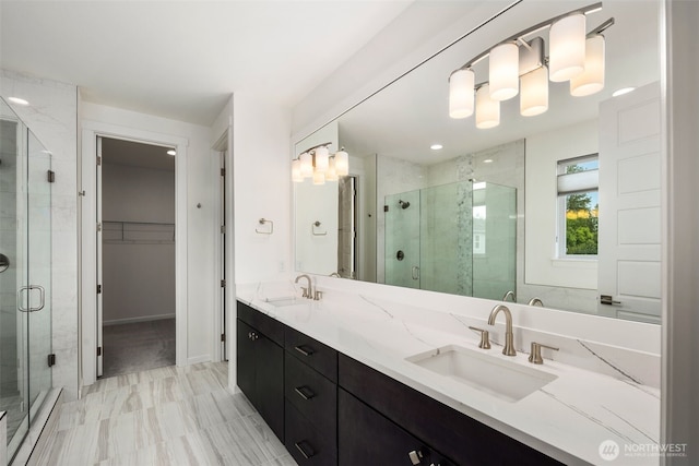 12619 176th St E, Puyallup, WA 98374 - bathroom featuring a shower stall, double vanity, marble look tile flooring, and a walk in closet