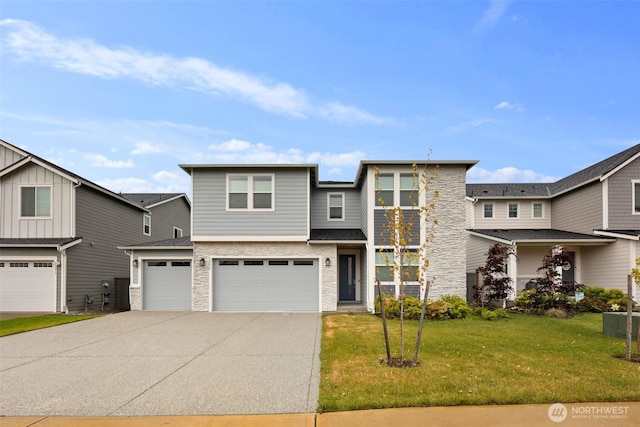 12619 176th St E, Puyallup, WA 98374 - view of front facade featuring stone siding, concrete driveway, a garage, and a front yard