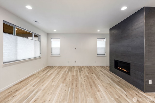 12619 176th St E, Puyallup, WA 98374 - unfurnished living room with wood finished floors, plenty of natural light, a large fireplace, and recessed lighting