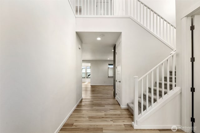 12619 176th St E, Puyallup, WA 98374 - staircase featuring wood finished floors, a towering ceiling, and recessed lighting