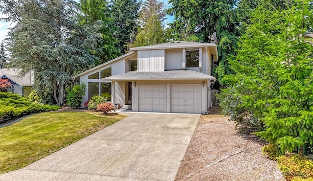 16410 92nd Ave E, Puyallup, WA 98375 - view of front of house with concrete driveway, a garage, a shingled roof, and a front lawn
