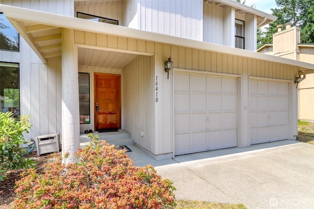 16410 92nd Ave E, Puyallup, WA 98375 - doorway to property with driveway, a garage, and a chimney