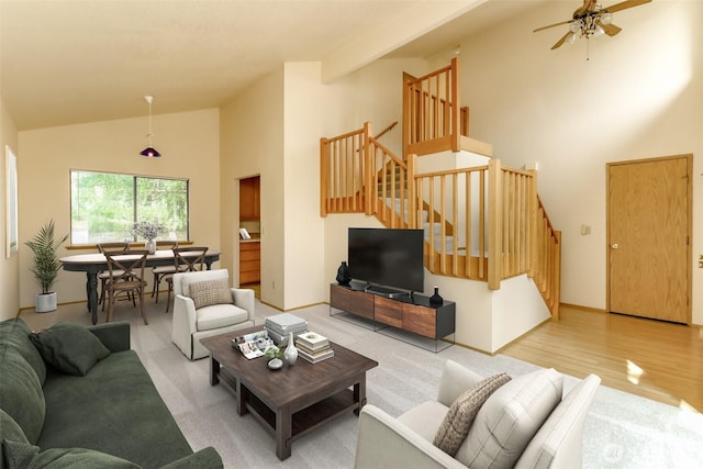 16410 92nd Ave E, Puyallup, WA 98375 - carpeted living room featuring stairway, high vaulted ceiling, ceiling fan, and wood finished floors