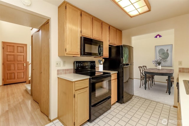 16410 92nd Ave E, Puyallup, WA 98375 - kitchen featuring black appliances, light countertops, and light colored carpet