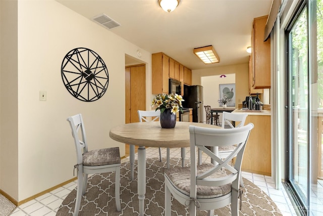 16410 92nd Ave E, Puyallup, WA 98375 - dining room featuring baseboards and light tile patterned floors