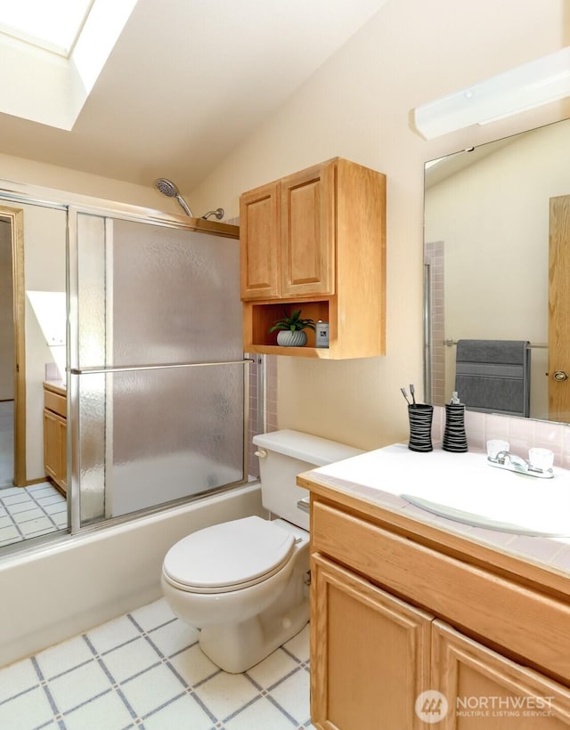 16410 92nd Ave E, Puyallup, WA 98375 - full bathroom featuring a skylight, vanity, bath / shower combo with glass door, and lofted ceiling