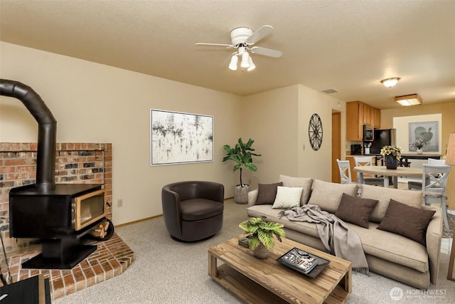 16410 92nd Ave E, Puyallup, WA 98375 - living area featuring carpet flooring, a wood stove, and a ceiling fan