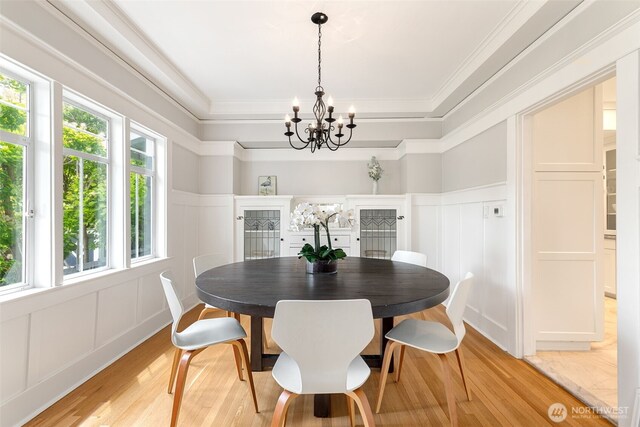 2823 34th Ave S, Seattle, WA 98144 - dining space with a decorative wall, light wood-style flooring, a chandelier, crown molding, and wainscoting
