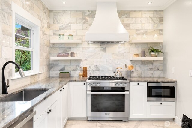 2823 34th Ave S, Seattle, WA 98144 - kitchen featuring appliances with stainless steel finishes, premium range hood, open shelves, ornamental molding, and white cabinetry