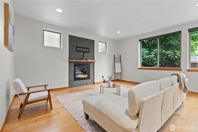 3800 SW Holden St, Seattle, WA 98126 - living room featuring recessed lighting, light wood-type flooring, and a tiled fireplace