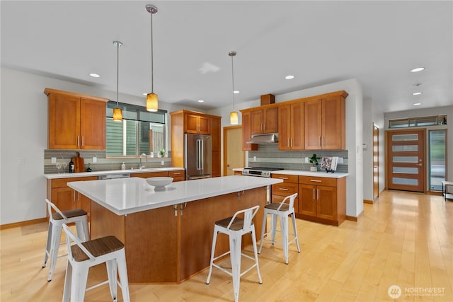 3800 SW Holden St, Seattle, WA 98126 - kitchen with stainless steel appliances, tasteful backsplash, a breakfast bar area, and recessed lighting