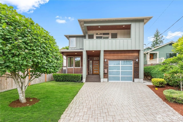 3800 SW Holden St, Seattle, WA 98126 - view of front facade with a balcony, a garage, decorative driveway, and board and batten siding