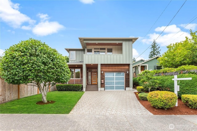 3800 SW Holden St, Seattle, WA 98126 - view of front facade featuring board and batten siding, driveway, a balcony, and a garage