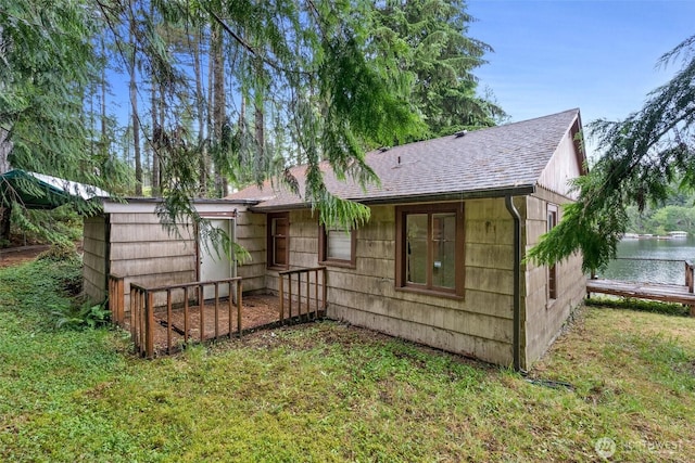 2120 E Spencer Lake Rd, Shelton, WA 98584 - back of property featuring a yard, roof with shingles, and a water view