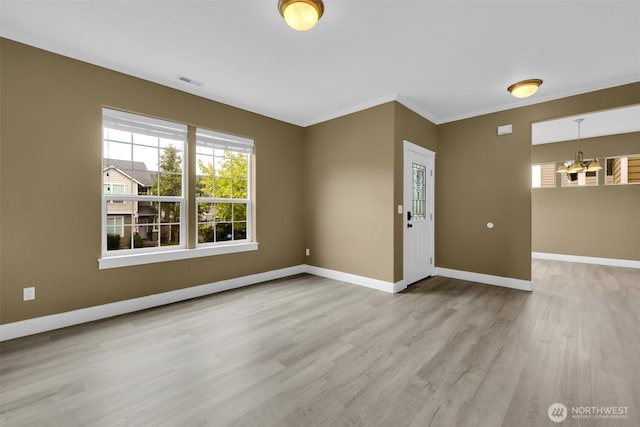 18527 97th Ave E, Puyallup, WA 98375 - empty room featuring wood finished floors, a chandelier, and ornamental molding