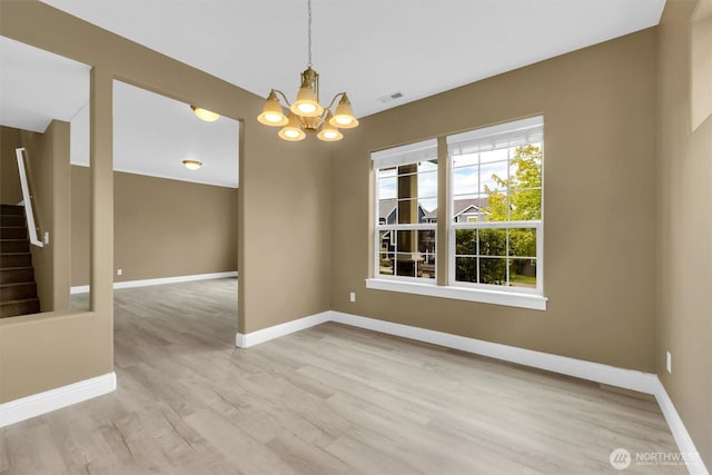 18527 97th Ave E, Puyallup, WA 98375 - empty room with a chandelier, light wood finished floors, and stairs