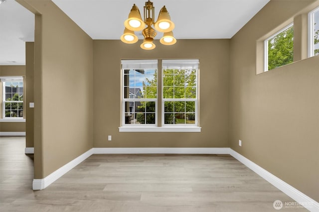 18527 97th Ave E, Puyallup, WA 98375 - unfurnished dining area with a chandelier and wood finished floors