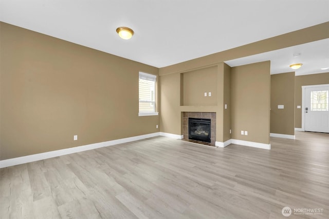 18527 97th Ave E, Puyallup, WA 98375 - unfurnished living room with light wood-style flooring and a tiled fireplace