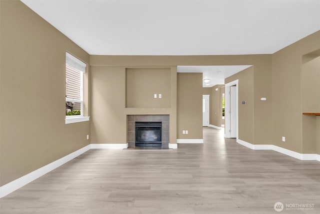 18527 97th Ave E, Puyallup, WA 98375 - unfurnished living room featuring light wood finished floors and a tiled fireplace