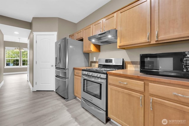18527 97th Ave E, Puyallup, WA 98375 - kitchen with appliances with stainless steel finishes, under cabinet range hood, light brown cabinetry, light wood-style flooring, and recessed lighting