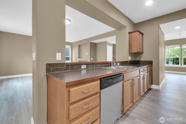 18527 97th Ave E, Puyallup, WA 98375 - kitchen featuring stainless steel dishwasher, dark countertops, light wood-type flooring, a peninsula, and recessed lighting