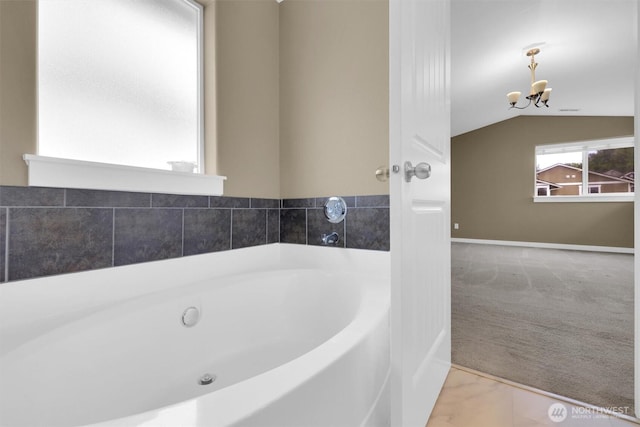 18527 97th Ave E, Puyallup, WA 98375 - bathroom with a chandelier, a garden tub, vaulted ceiling, and marble finish flooring