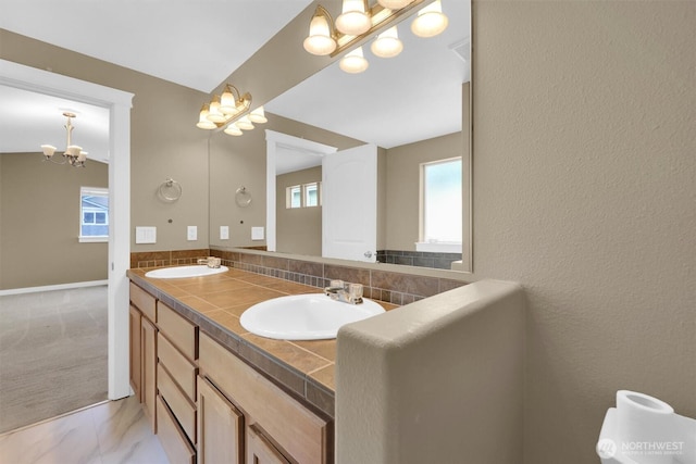 18527 97th Ave E, Puyallup, WA 98375 - bathroom with a chandelier, double vanity, and marble look tile flooring