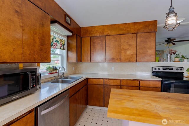 1328 Grant St, Walla Walla, WA 99362 - kitchen featuring stainless steel appliances, brown cabinets, hanging light fixtures, butcher block counters, and a ceiling fan
