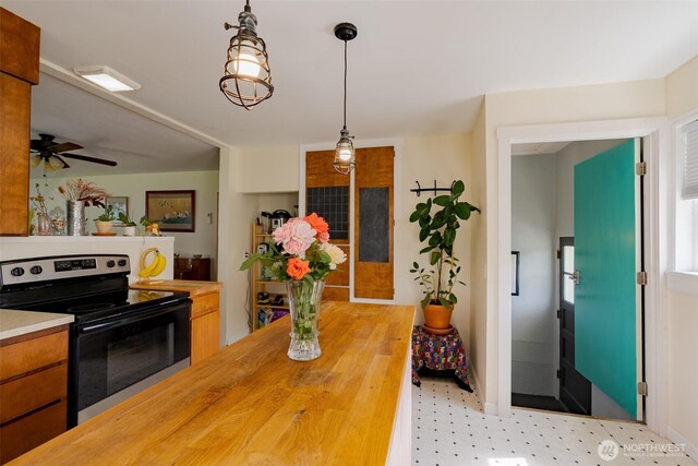 1328 Grant St, Walla Walla, WA 99362 - kitchen featuring electric stove, wooden counters, pendant lighting, brown cabinetry, and ceiling fan