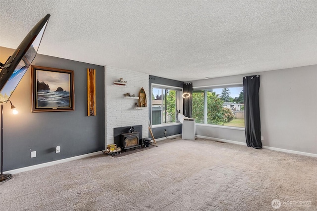 1401 Lum Rd, Centralia, WA 98531 - living room featuring a textured ceiling, a wood stove, and carpet flooring