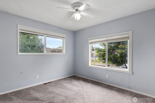 1401 Lum Rd, Centralia, WA 98531 - carpeted empty room featuring healthy amount of natural light, a textured ceiling, and a ceiling fan