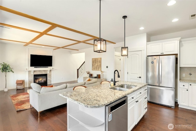 1803 65th Ct SE, Tumwater, WA 98501 - kitchen with appliances with stainless steel finishes, dark wood-type flooring, white cabinetry, a fireplace, and recessed lighting