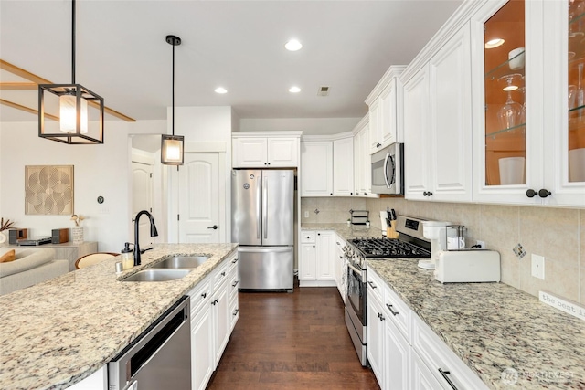 1803 65th Ct SE, Tumwater, WA 98501 - kitchen featuring appliances with stainless steel finishes, light stone counters, white cabinetry, glass insert cabinets, and recessed lighting