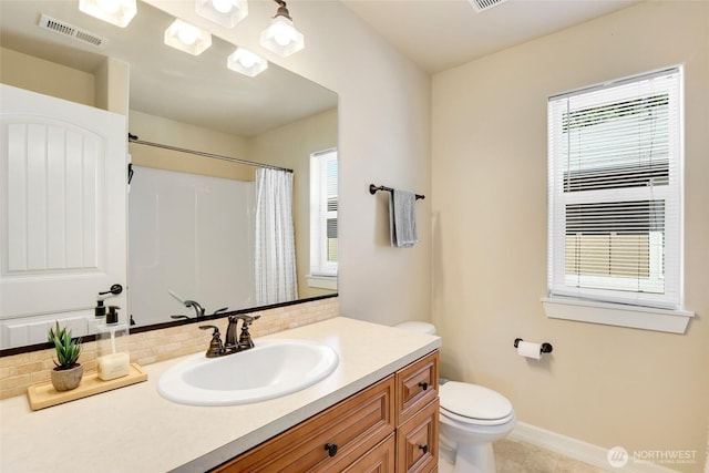 1803 65th Ct SE, Tumwater, WA 98501 - full bathroom with vanity, healthy amount of natural light, a shower with shower curtain, and tasteful backsplash