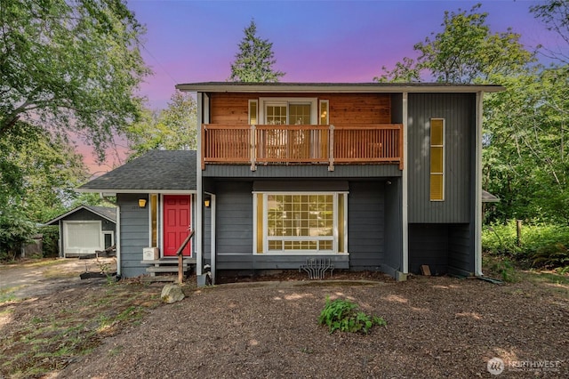 10564 14th Ave S, Seattle, WA 98168 - view of front of house featuring a balcony, entry steps, and an outbuilding