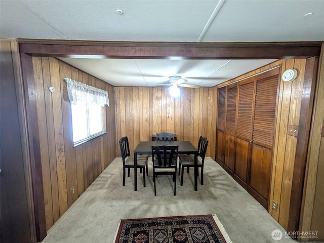 2302 R St SE Unit 108, Auburn, WA 98002 - dining space featuring carpet floors and wood walls